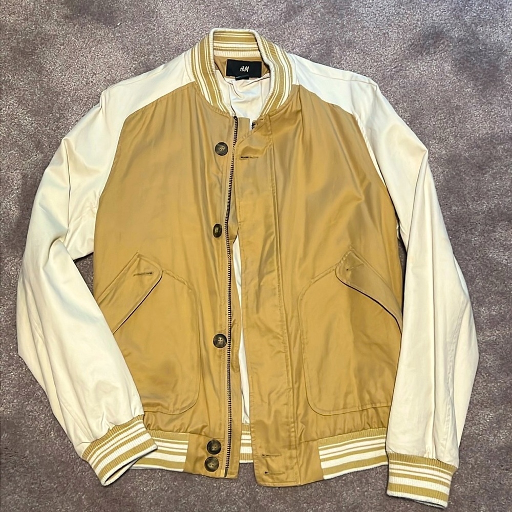 This H&M size medium jacket blends a classic varsity style with a modern twist.